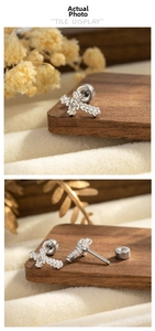 Detail view of gothic lace cross stud earrings with secure screw-back design