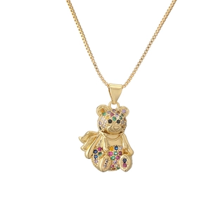 Golden teddy bear pendant necklace with vibrant colorful gemstones on a fine gold chain