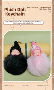 Detail of plush sleeping doll keychain with pink and black fur pom-pom and gold rings