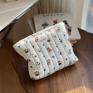 Close-up of quilted cotton makeup bag with cute bear patterns and simple wish label