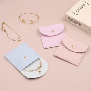 Flat lay of colorful PU leather jewelry pouches for rings and bracelets storage