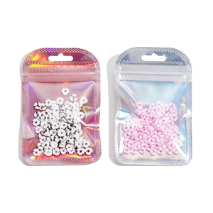Macro view of colorful holographic resealable bags for jewelry with spotted clay beads