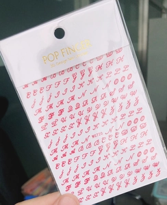 Detail view of red 3D cursive alphabet nail stickers in professional packaging