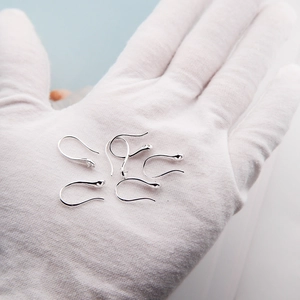 Macro detail of six polished s925 silver earring hooks for DIY pearl jewelry making