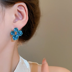 Macro view of geometric blue zircon clover earrings with 18k gold plated silver pins