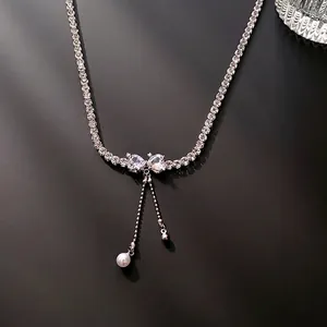 Silver bow necklace with zircon tennis chain and elegant faux pearl tassel pendant