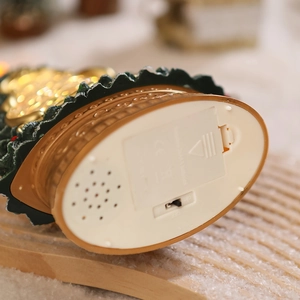 Detail view of the base featuring the battery compartment and speaker for the music box
