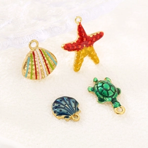 Detailed macro view of colorful enamel starfish, turtle, and seashell jewelry pendants