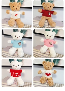 Detail of plush teddy bears in brown and white wearing colorful knitted sweaters