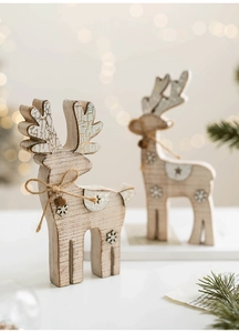 Close-up of wooden reindeer decor with snowflake engraving and rustic jute rope details