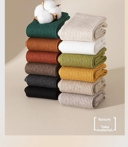 Detailed macro view of multi-color ribbed cotton socks showcasing retro earth tone textures