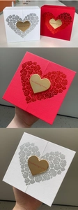 Detail of red and white double-opening jewelry boxes with embossed rose heart pattern