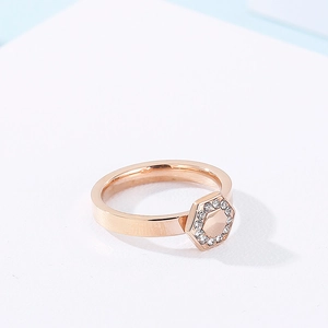 Detailed macro shot of rose gold hexagonal ring with sparkling pavé-set rhinestones