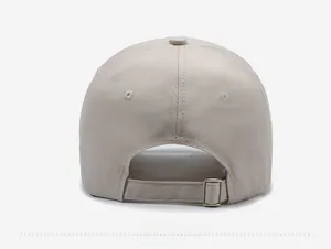 Detail of adjustable metal buckle and stitching on beige distressed cotton baseball cap