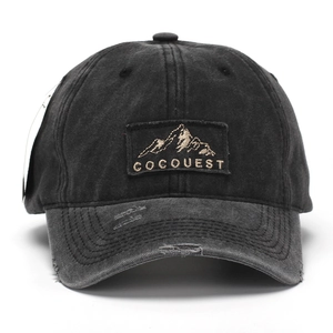 Retro washed charcoal baseball cap with COCOQUEST mountain patch and distressed brim details