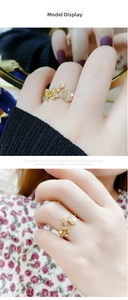 Detail of adjustable gold ring with floral leaf pattern and sparkling cubic zirconia