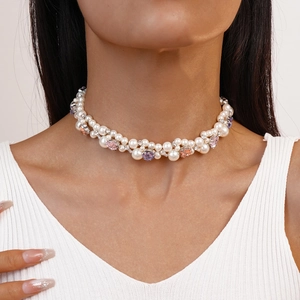 Double-layered pearl necklace with pink and purple rhinestones worn by a model