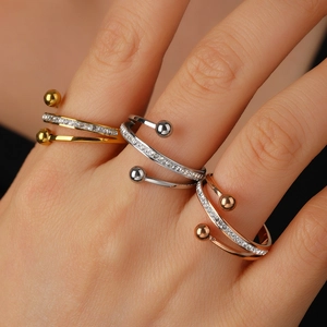 Three-piece set of spiral open rings in gold, silver and rose gold with micro-inlaid zircons