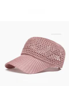 Detailed close-up of pink breathable mesh baseball cap with hollow crochet weave design