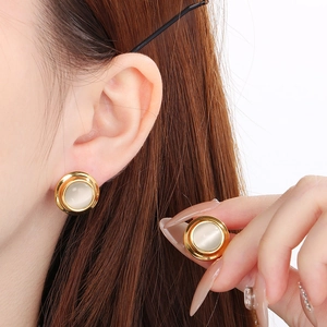 Elegant round stainless steel earrings with gold border and opal-style gemstone