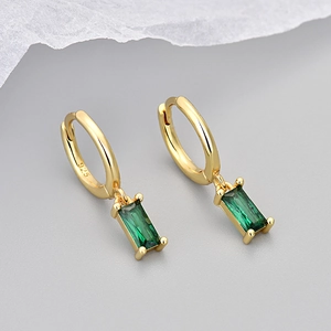 Detailed macro view of S925 sterling silver gold earrings with green zircon stones
