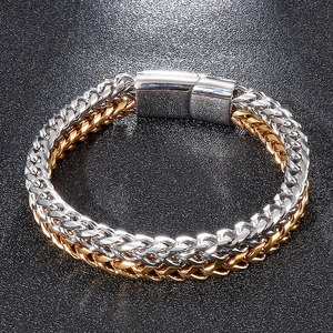 Detail view of two-tone gold and silver double-layered chain bracelet for men