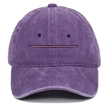 Detail of Ditto embroidered expression on a purple washed cotton baseball cap