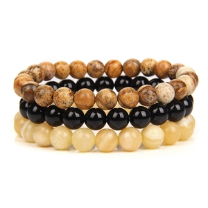 Detailed macro view of stacked 8mm natural stone beads including black onyx and agate