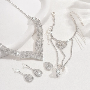 Luxurious silver bridal jewelry set with water drop rhinestones and heart fringe details