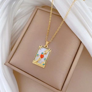 Detail view of The Lovers tarot necklace with shell inlay and gold-tone chain