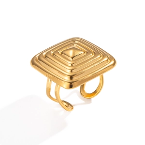 Macro detail of a gold square tiered pyramid ring with adjustable open band design