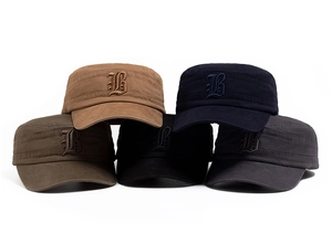 Detailed close-up of embroidered letter B on flat top cotton army caps in various colors