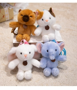 Detail showing plush elephant, bunny and cat charms with soft fur and fashion tags