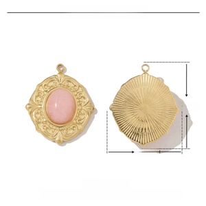 Macro detail of a 23x19mm gold stainless steel heart pendant with pink stone inlay