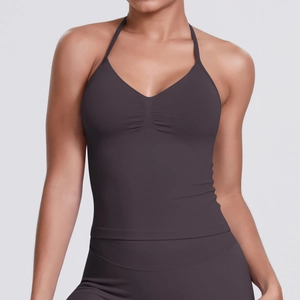 Close-up of the pleated center detail and ribbed texture of a halter neck sports bra