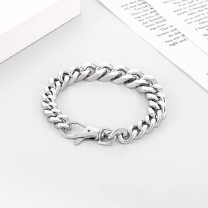Detail shot of silver Miami Cuban chain with lobster clasp on a minimalist background