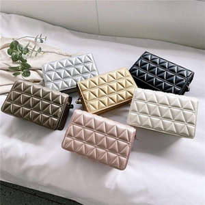 Top view of geometric quilted crossbody bags in six metallic and pastel colors on white bedding