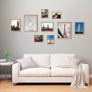 Nine-piece set of wooden photo frames featuring world landmarks on a Nordic style wall