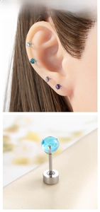 Macro shot of titanium steel colorful gemstone ear studs with flat-back screw ball closure