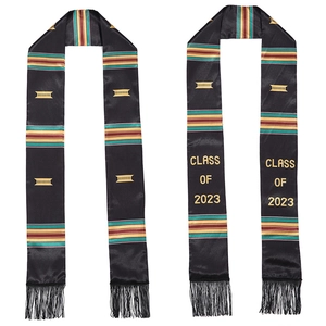 Close-up of black satin graduation stoles with Kente patterns and gold 2023 lettering