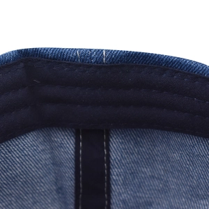 Detail of multi-row stitching on blue denim baseball cap inner sweatband and fabric