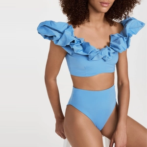 Close-up of sky blue two-piece swimsuit with ruffled off-shoulder top and high waist bottom