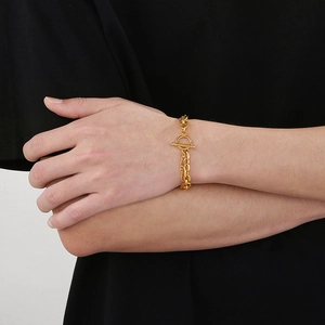 Close-up of gold stainless steel double Cuban chain bracelet with OT toggle clasp