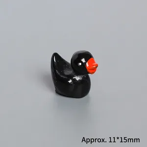 Miniatur Entenfigur aus schwarzem Harz mit glänzender Oberfläche und orangefarbenem Schnabel