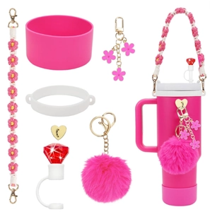 Pink accessory set with woven handle, pompom, and ruby straw cover for tumbler