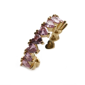 Detailed view of adjustable gold ring with pink heart-shaped cubic zirconia stones