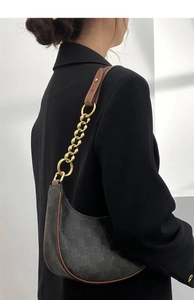 Close-up of a dark grey monogram hobo bag with gold chain strap and leather trim detail
