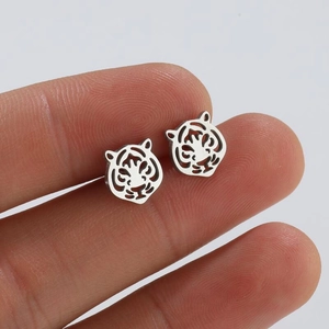 Sleek cutout tiger head stud earrings in silver-tone metal for a bold animal style