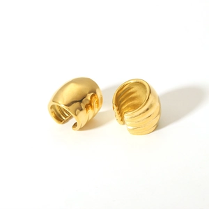 Detail shot of gold-plated ear cuffs with unique textured horizontal ripple pattern