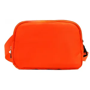 Detailed macro view of orange nylon crossbody bag featuring black zipper and plastic buckles